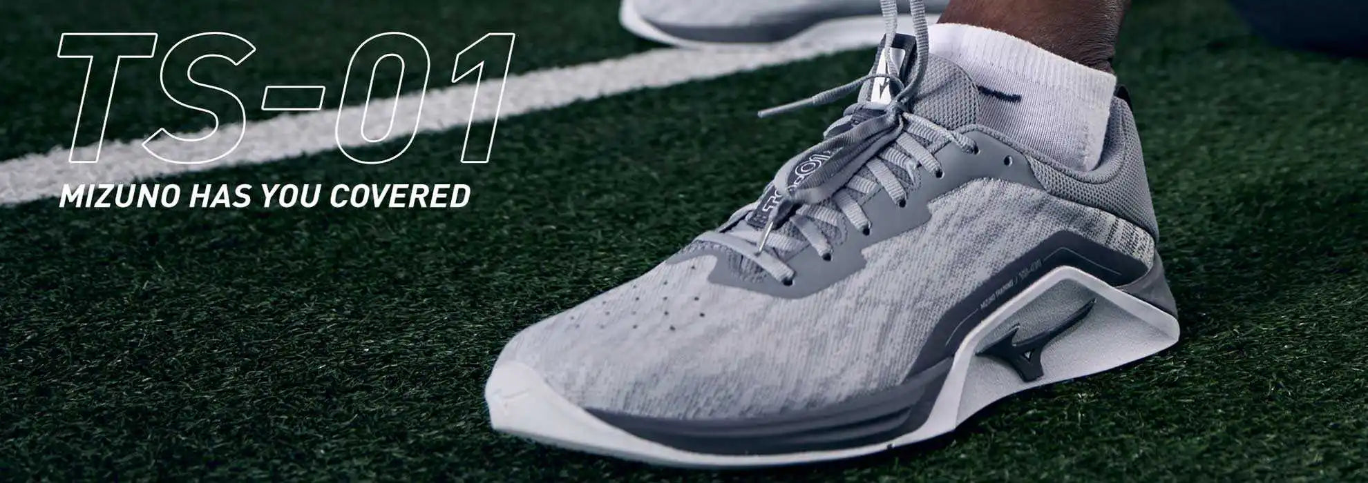 A light gray athletic shoe with white accents and dark gray sole.