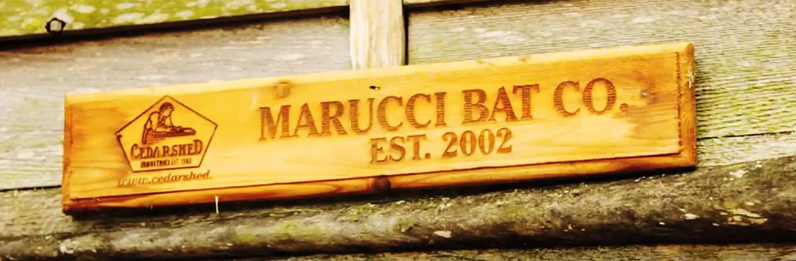 A wooden sign for Marucci Bat Co., established 2002.